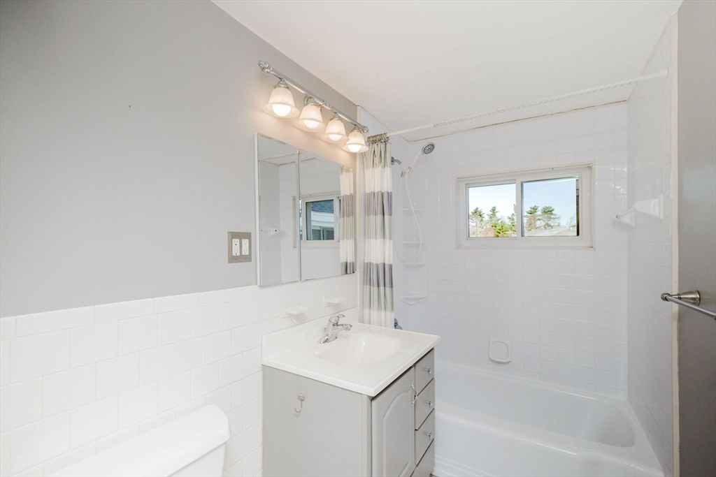 43 Will Drive, Unit 30 Canton, MA 02021 - Photo 18 of 25 a bathroom with a sink mirror and a bathtub