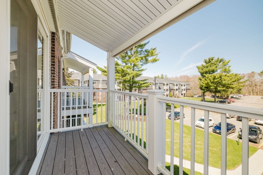 43 Will Drive, Unit 30 Canton, MA 02021 - Photo 19 of 25 a view of a balcony with wooden floor and fence