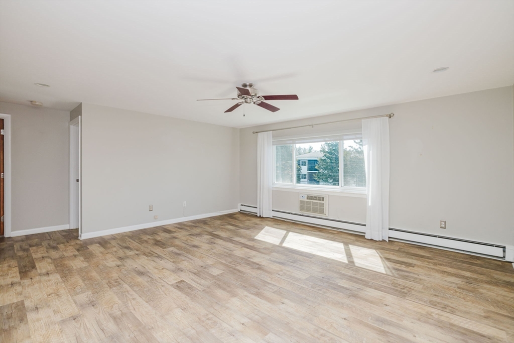 43 Will Drive, Unit 30 Canton, MA 02021 - Photo 5 of 25 wooden floor in an empty room with a window