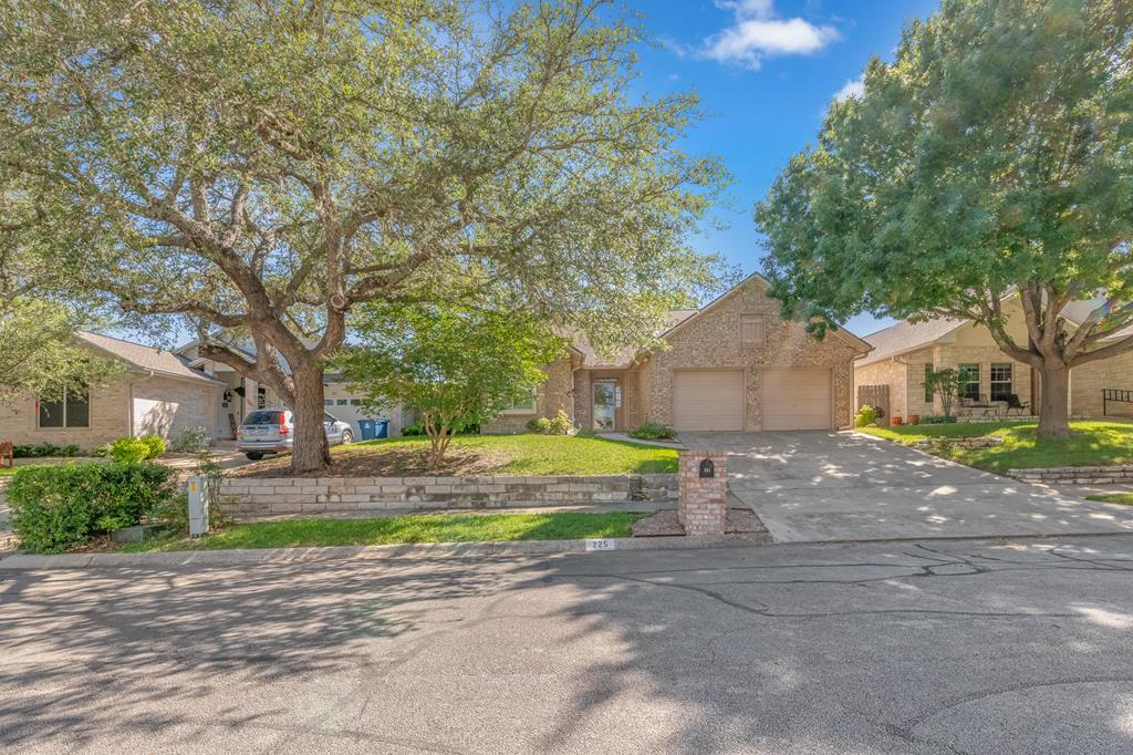 225 Los Cedros Loop Kerrville, TX 78028 - Photo 1 of 27 a view of a house with a yard and large tree
