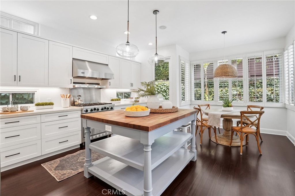587 26th Street Manhattan Beach, CA 90266 - Photo 19 of 67 a kitchen with kitchen island a stove a table and chairs in it