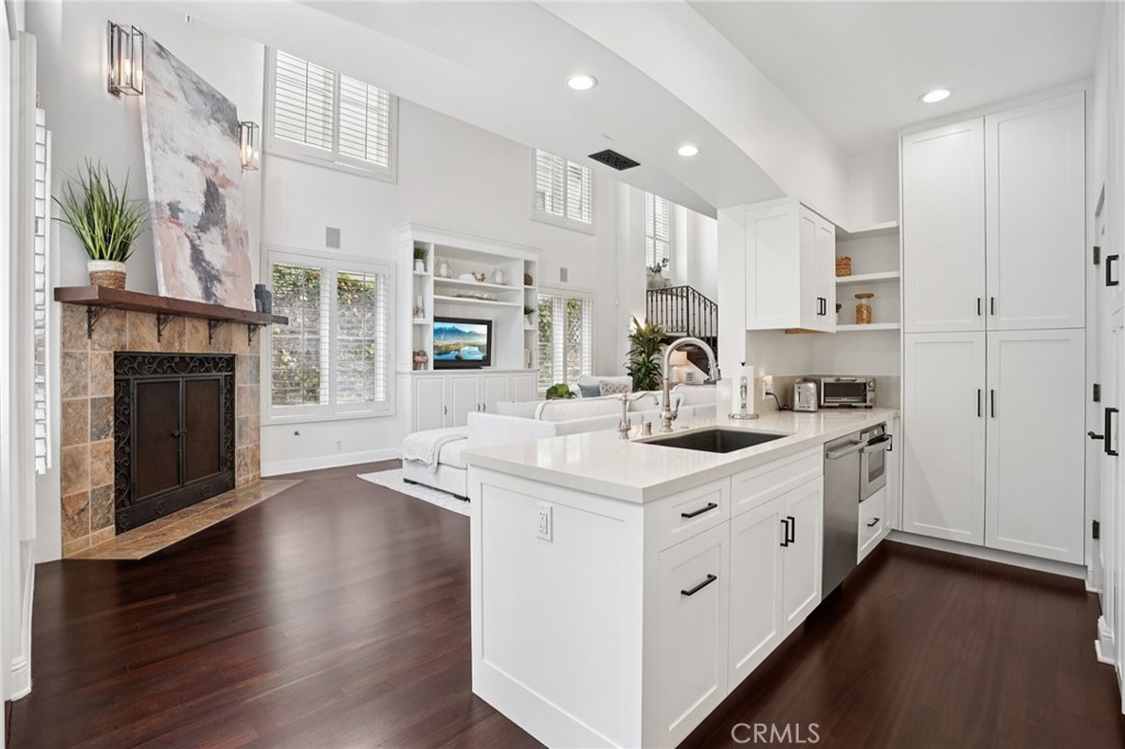 587 26th Street Manhattan Beach, CA 90266 - Photo 20 of 67 a kitchen with stainless steel appliances a white stove top oven cabinets a sink and a potted plant
