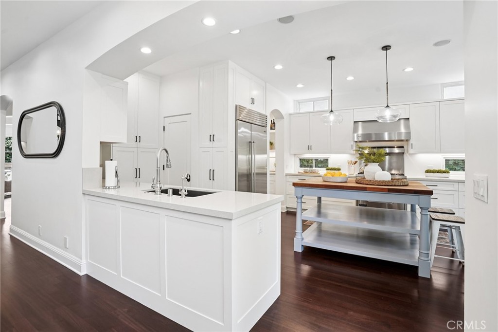 587 26th Street Manhattan Beach, CA 90266 - Photo 22 of 67 a kitchen with kitchen island white cabinets and stainless steel appliances
