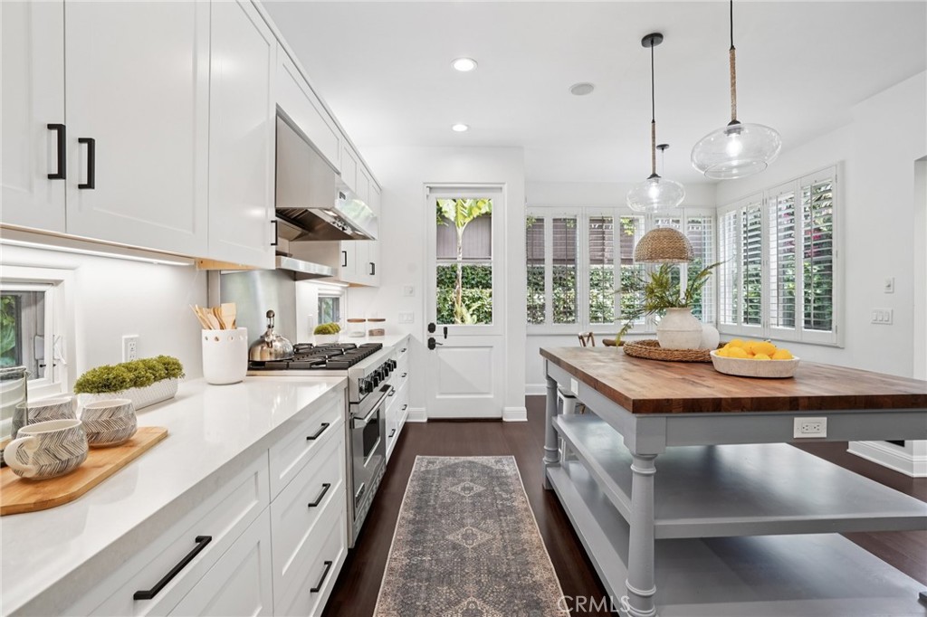 587 26th Street Manhattan Beach, CA 90266 - Photo 23 of 67 a kitchen with stainless steel appliances granite countertop a stove a sink and a wooden floors