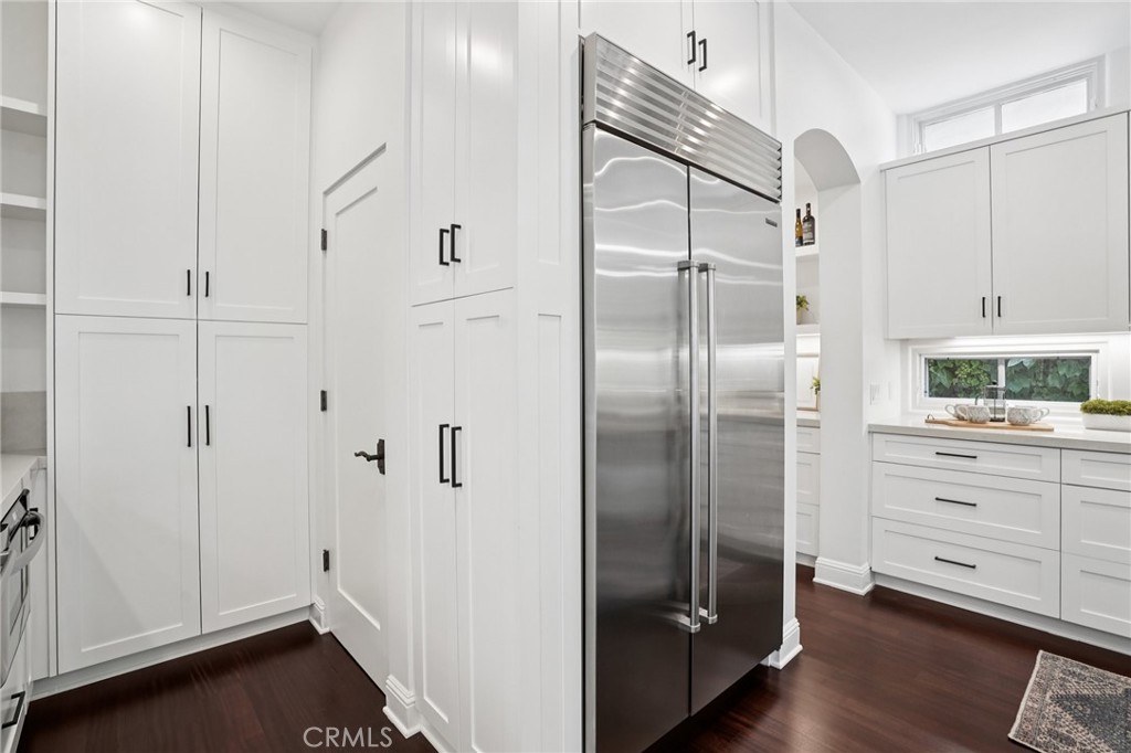 587 26th Street Manhattan Beach, CA 90266 - Photo 26 of 67 a kitchen with white cabinets and stainless steel appliances