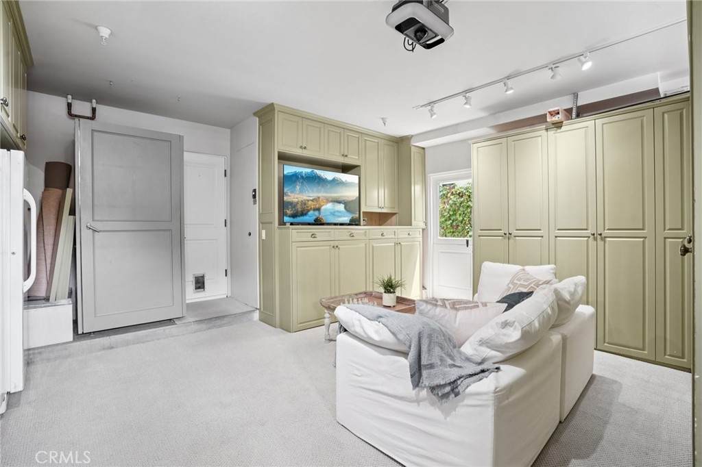 587 26th Street Manhattan Beach, CA 90266 - Photo 56 of 67 a living room with furniture and a glass door shower