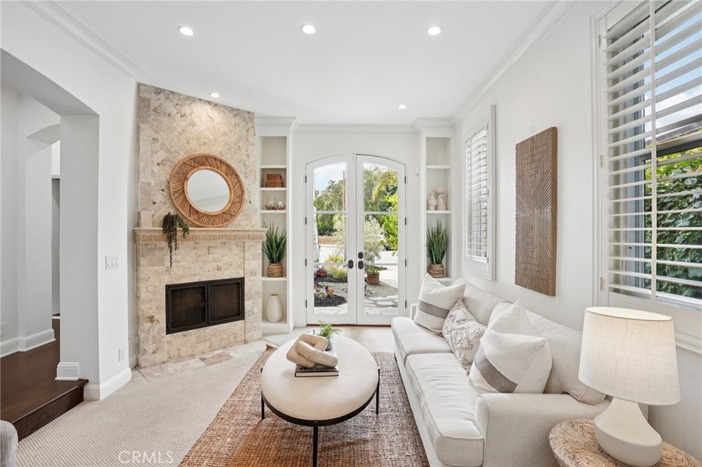 587 26th Street Manhattan Beach, CA 90266 - Photo 7 of 67 a living room with furniture a fireplace and a floor to ceiling window