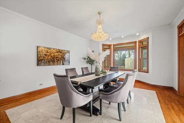 a living room with furniture a fireplace and large windows