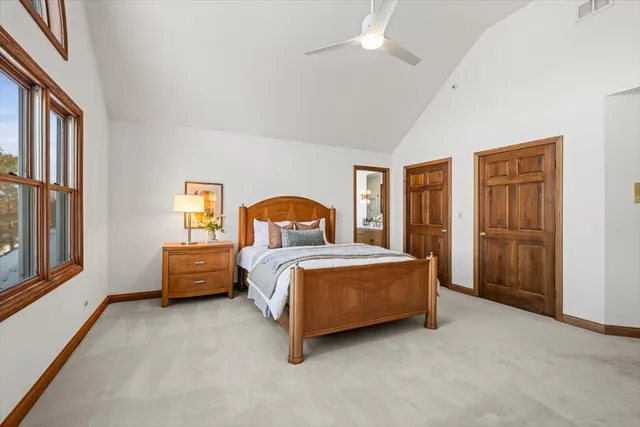 a spacious bedroom with a bed and a window