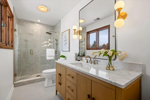 a bathroom with a double vanity sink a and a mirror