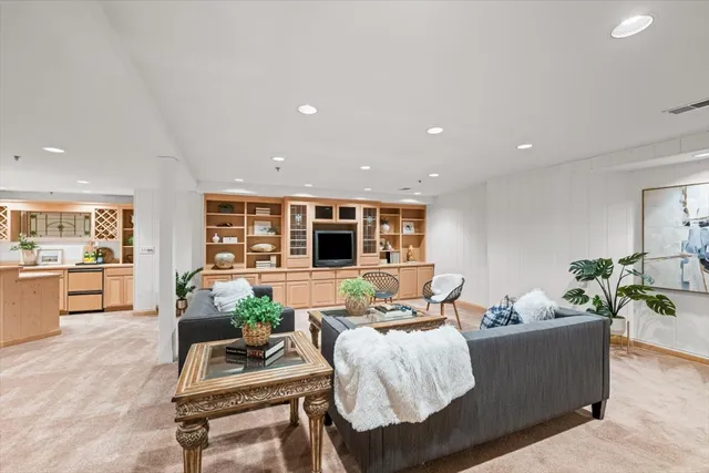 a view of staircase with white walls and a rug