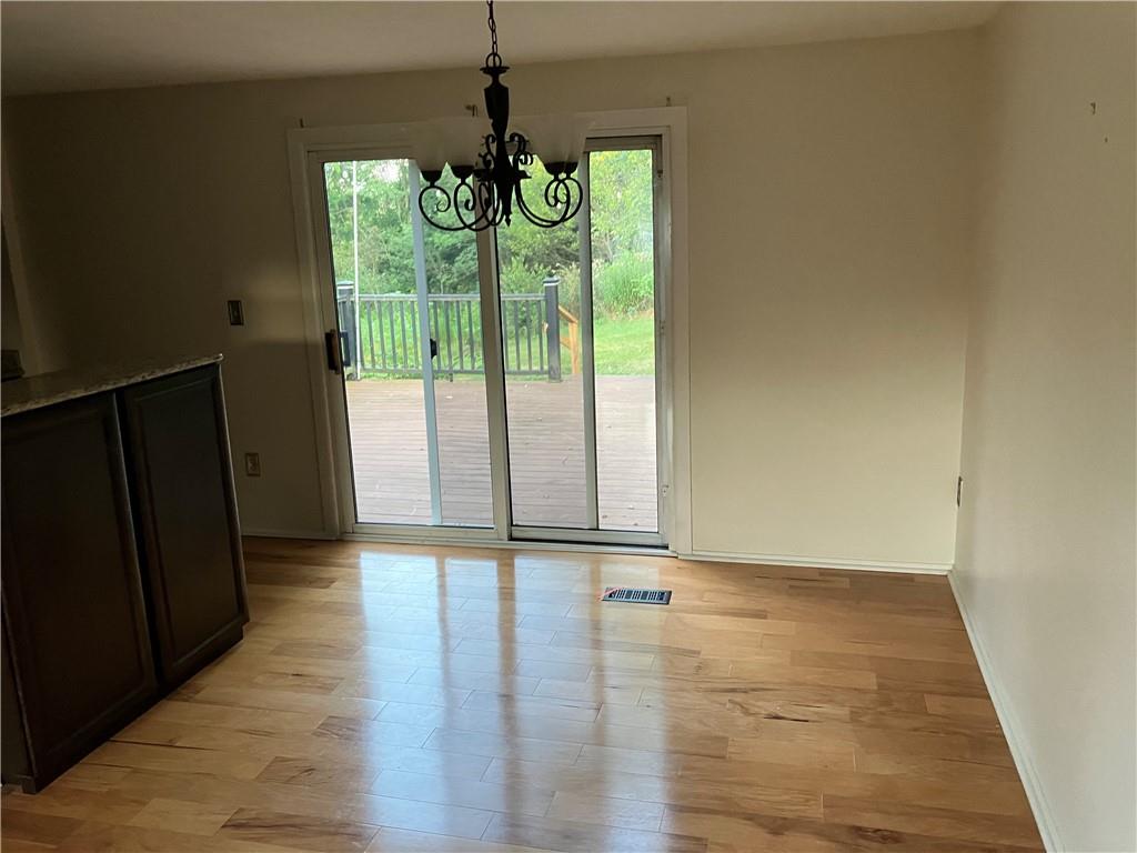 54 Bock Lane Baden, PA 15005 - Photo 11 of 25 a view of an empty room with wooden floor and a window