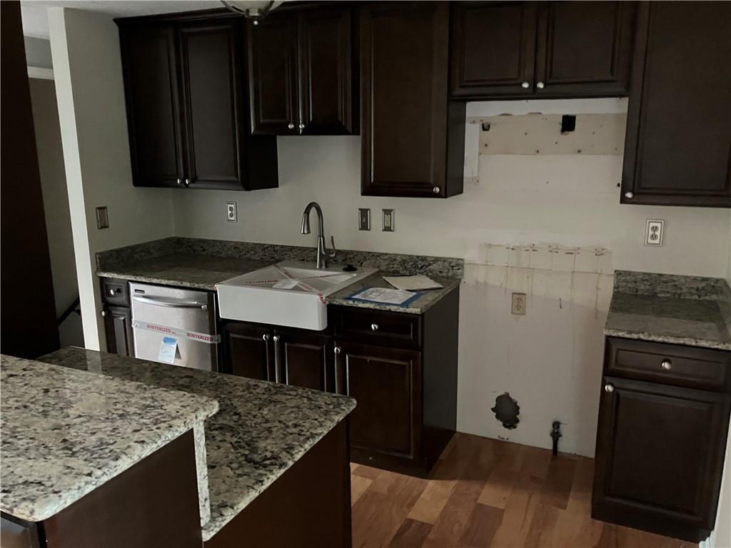 54 Bock Lane Baden, PA 15005 - Photo 12 of 25 a kitchen with stainless steel appliances granite countertop a sink stove and microwave