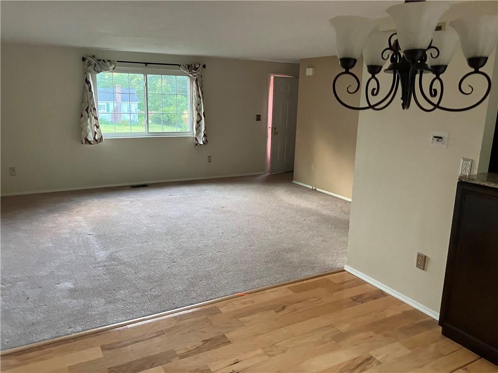 54 Bock Lane Baden, PA 15005 - Photo 10 of 25 an empty room with a window and wooden floor
