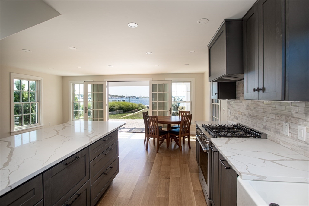 2043 Main Road Westport, MA 02791 - Photo 11 of 42 a kitchen with a table chairs stove and kitchen island