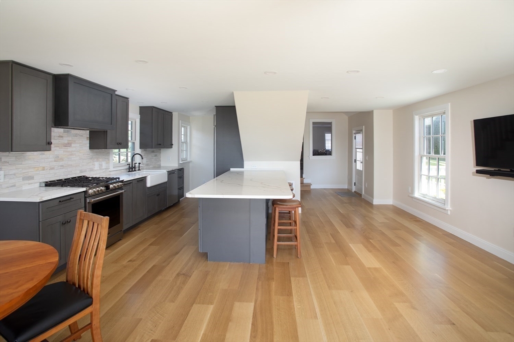 2043 Main Road Westport, MA 02791 - Photo 12 of 42 a kitchen with stainless steel appliances a sink a stove a microwave a counter top space and cabinets