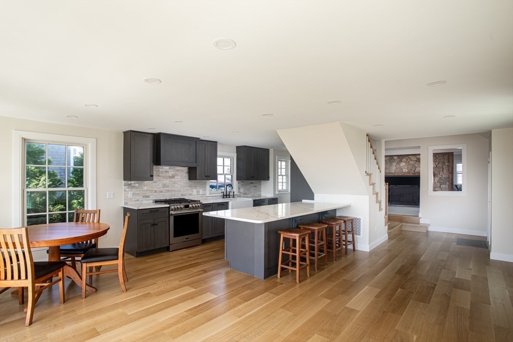2043 Main Road Westport, MA 02791 - Photo 14 of 42 a view of a kitchen with kitchen island a dining table and chairs