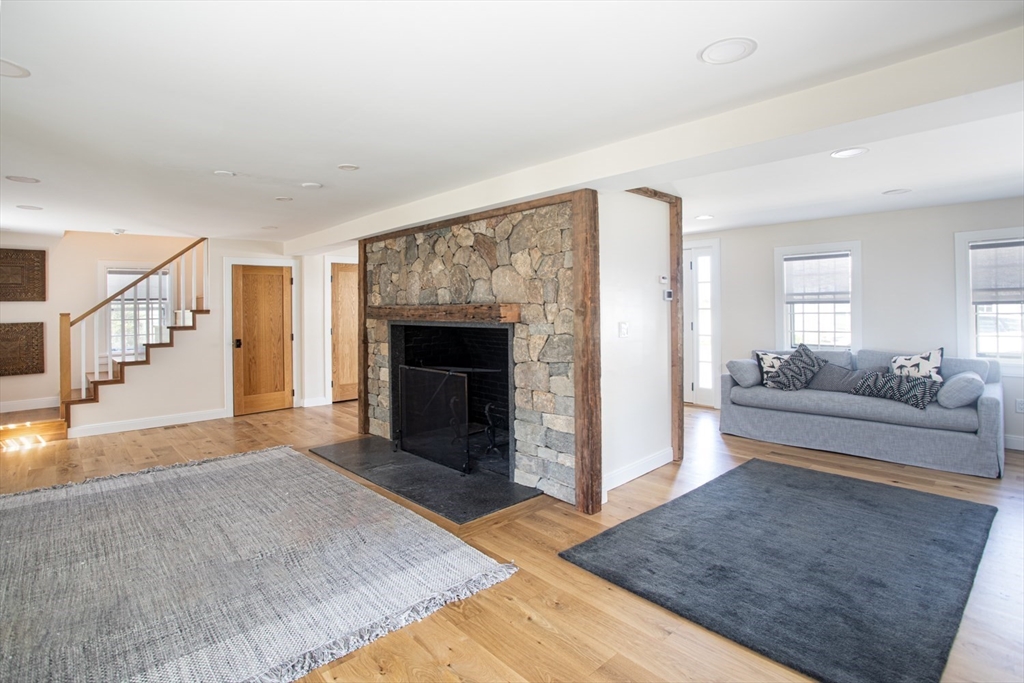 2043 Main Road Westport, MA 02791 - Photo 17 of 42 a living room with furniture and a fireplace
