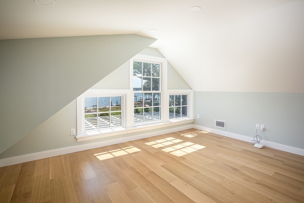 2043 Main Road Westport, MA 02791 - Photo 25 of 42 an empty room with wooden floor and windows