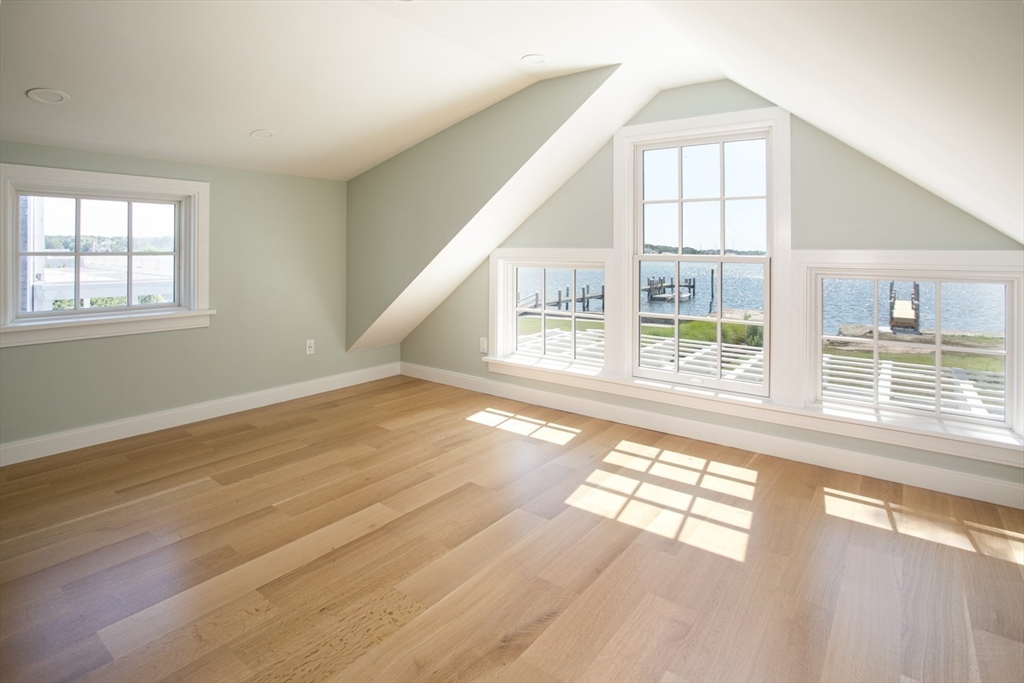 2043 Main Road Westport, MA 02791 - Photo 26 of 42 an empty room with wooden floor and windows