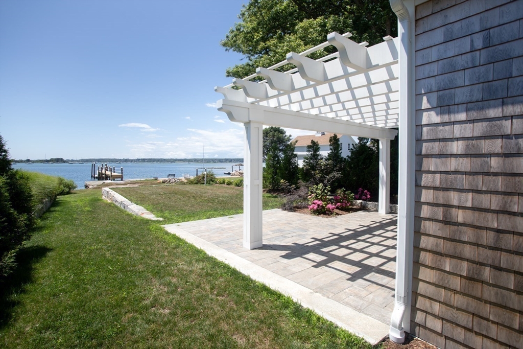 2043 Main Road Westport, MA 02791 - Photo 33 of 42 a view of a patio with lawn chairs floor to ceiling window and yard