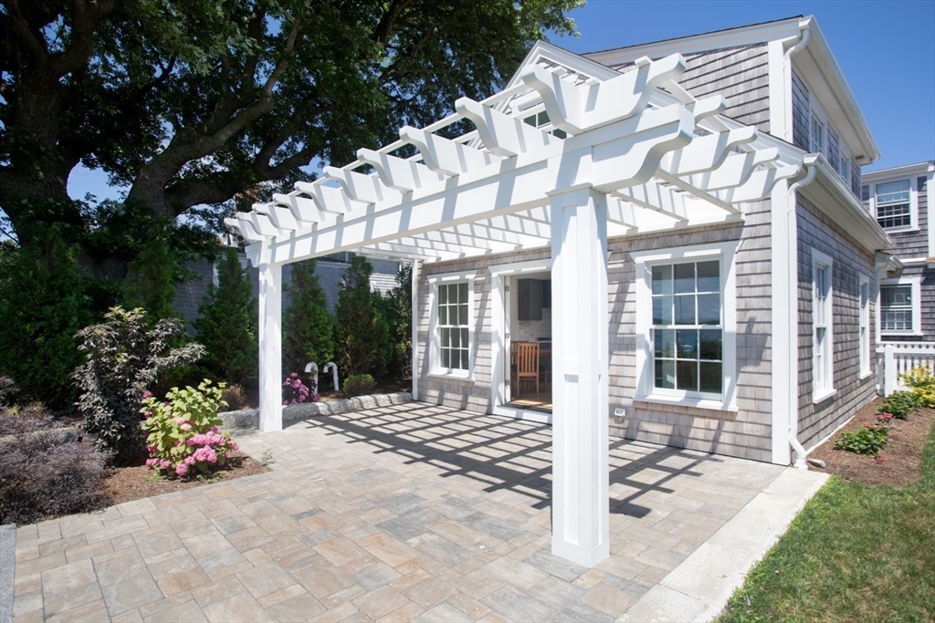 2043 Main Road Westport, MA 02791 - Photo 34 of 42 front view of a brick house with a large window and potted plants