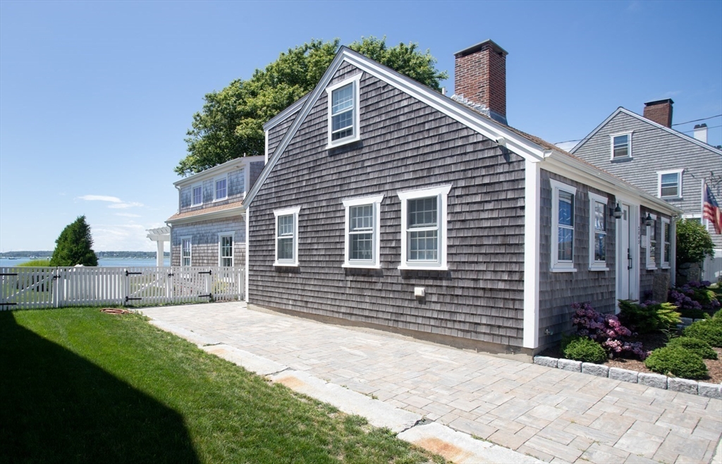 2043 Main Road Westport, MA 02791 - Photo 7 of 42 a front view of a house with a yard and garage
