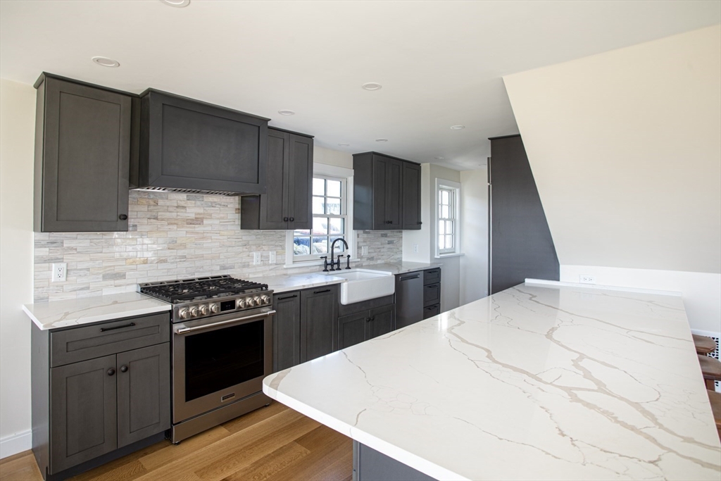2043 Main Road Westport, MA 02791 - Photo 9 of 42 a kitchen with a sink a stove and refrigerator