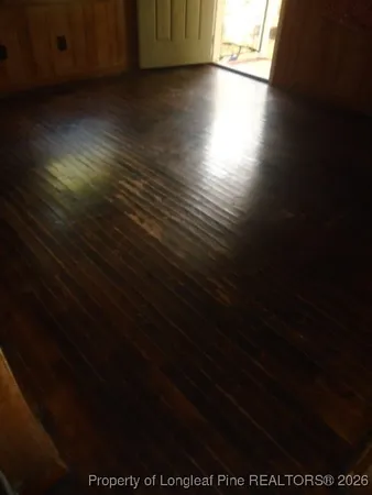 a view of an empty room and wooden floor