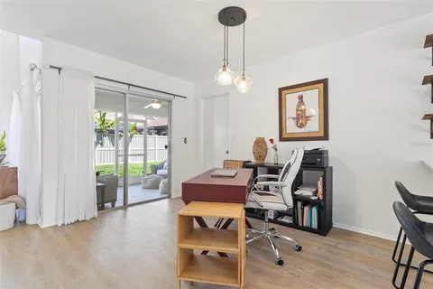 a view of a workspace with furniture and a chandelier