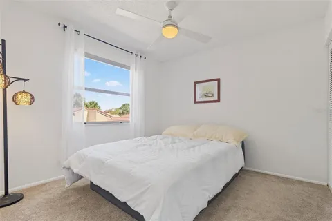 a bedroom with a bed and painting on the wall