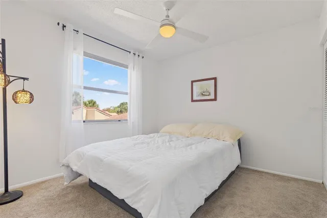 a bedroom with a bed and painting on the wall