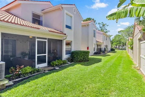a view of a house with a yard and plants