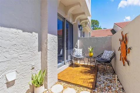 a view of an chairs and table in the patio