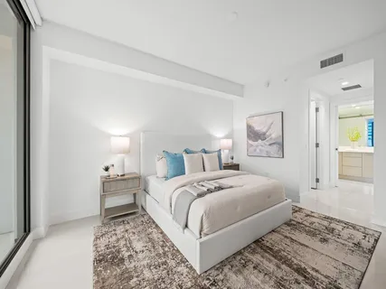 a bedroom with a bed and a lamp