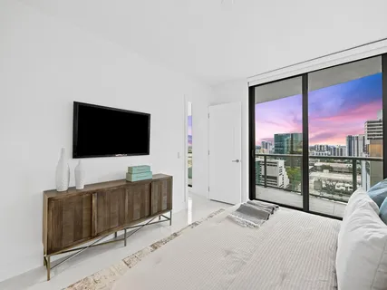 a bedroom with a bed and a flat screen tv