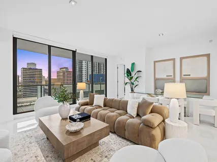 a living room with furniture and a large window