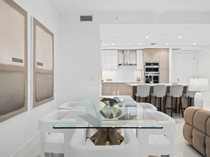 a living room with furniture and kitchen view