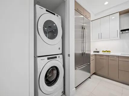 a utility room with sink dryer and washer