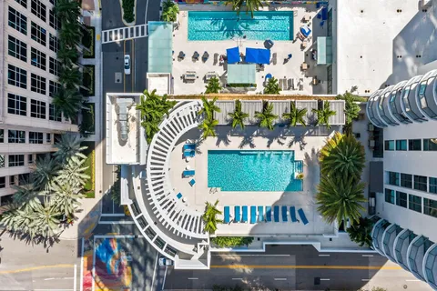 a view of a house with backyard and swimming pool