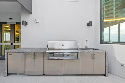 a view of a patio with couches table and chairs and potted plants