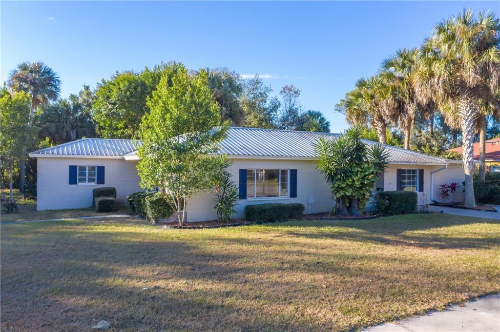 2240 Southland Road Mount Dora, FL 32757 - Photo 1 of 1 a view of a house with a yard