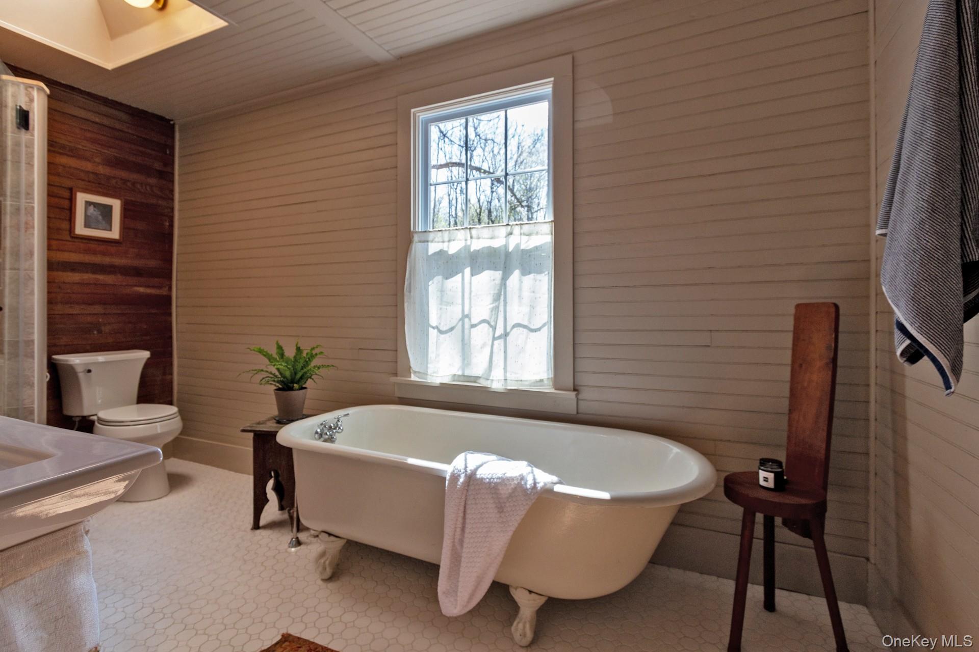 692 County Rte 2 Elizaville, NY 12523 - Photo 16 of 33 a bathroom with a bathtub and a window