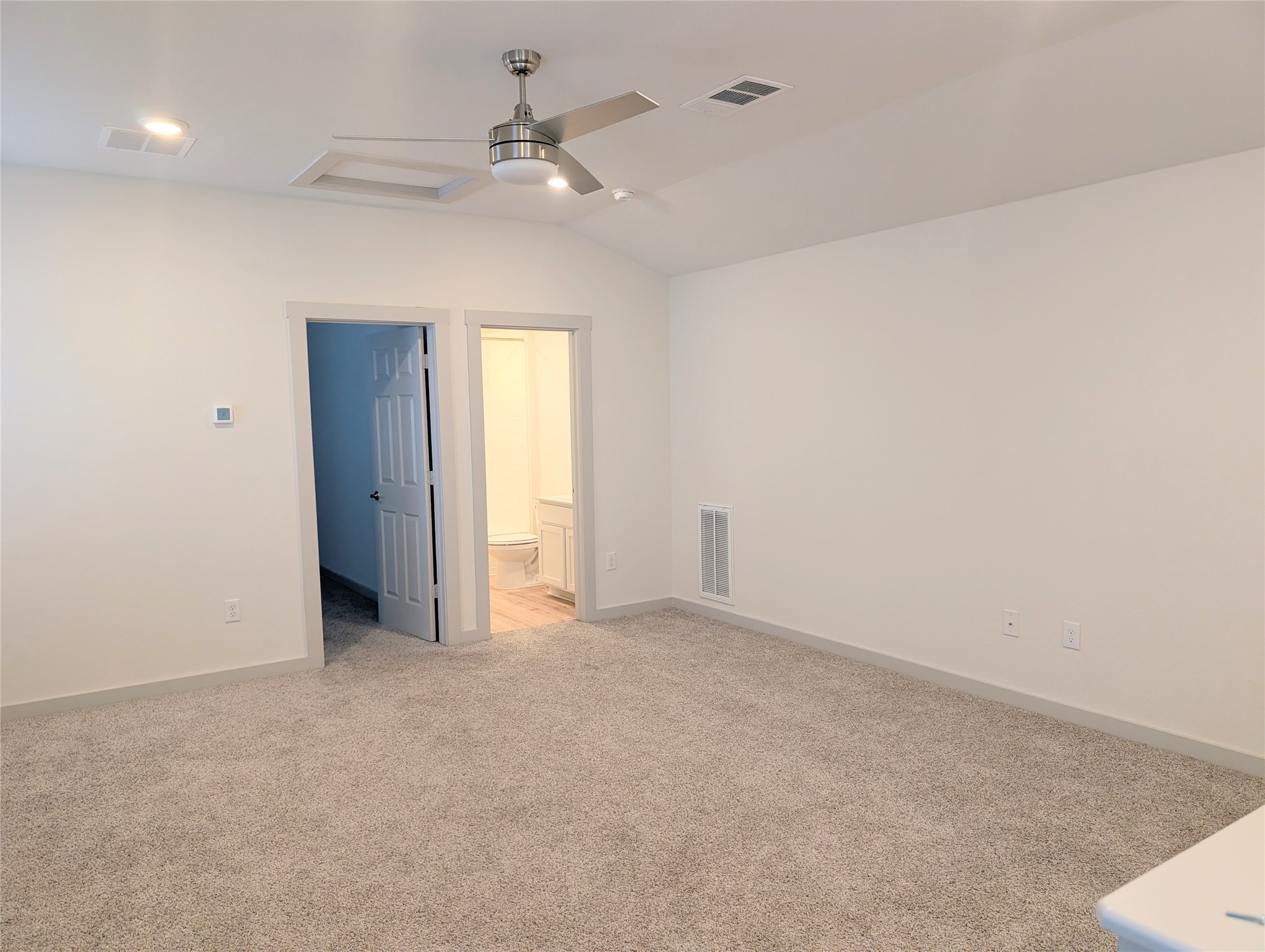 261 Century Plant Road Leander, TX 78641 - Photo 18 of 25 A well-lit bedroom features plush carpeting and a modern ceiling fan for ultimate comfort.