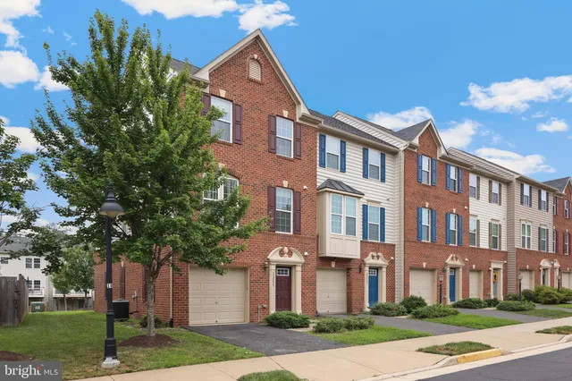 a front view of a residential apartment building with a yard
