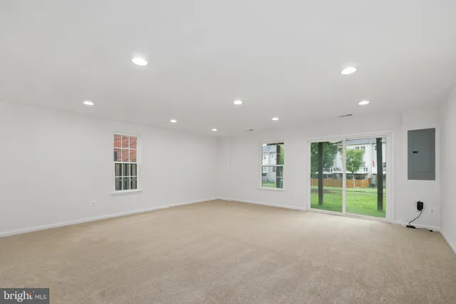 an empty room with a projector and white walls