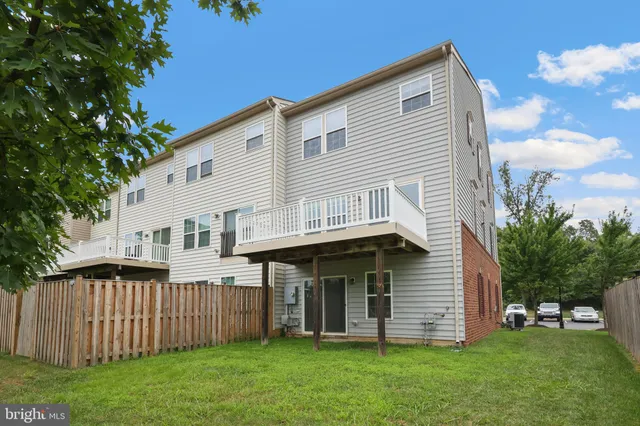 a view of a house with a yard and deck