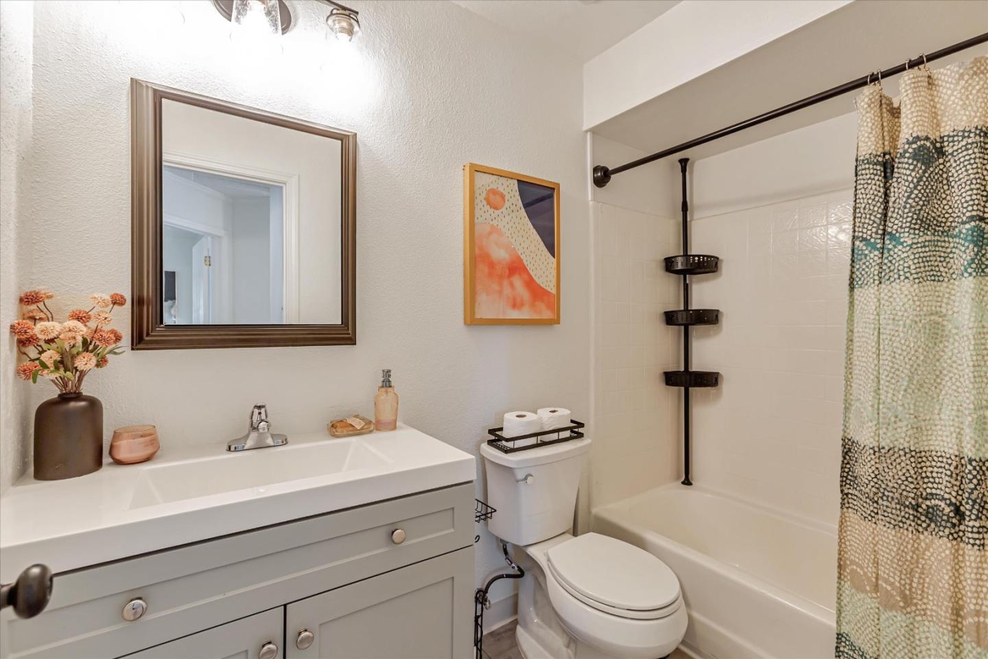 2575 Oak Road, Unit B Walnut Creek, CA 94597 - Photo 13 of 20 a bathroom with a sink a mirror a toilet and shower