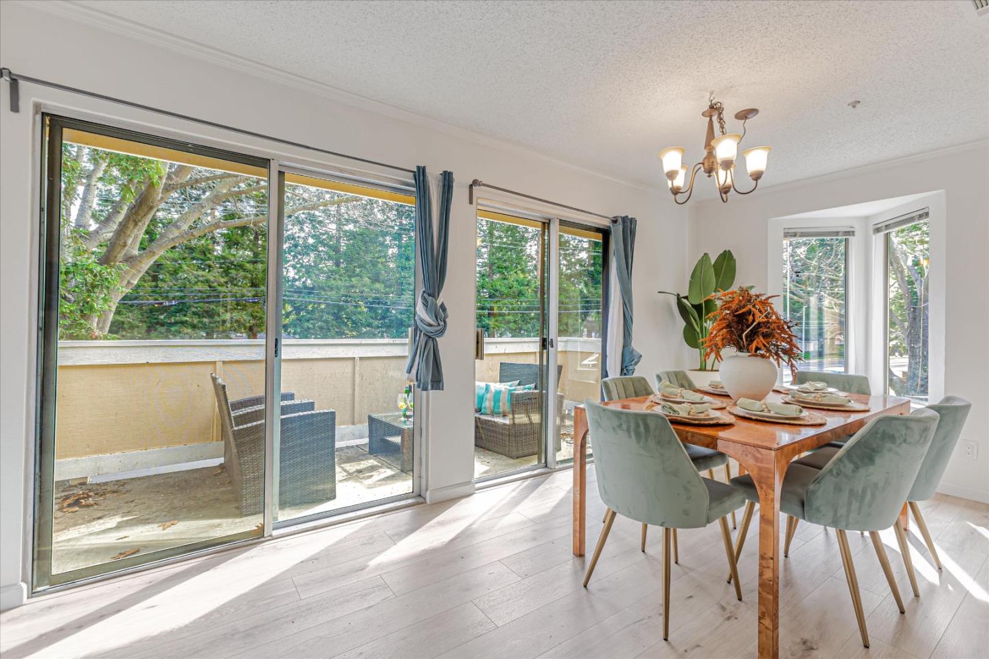 2575 Oak Road, Unit B Walnut Creek, CA 94597 - Photo 8 of 20 a dining room with furniture a chandelier and wooden floor