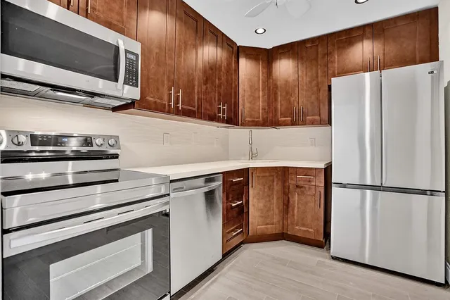 a kitchen with stainless steel appliances a refrigerator stove and microwave